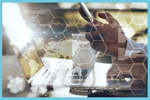 man holding phone next to laptop keyboard